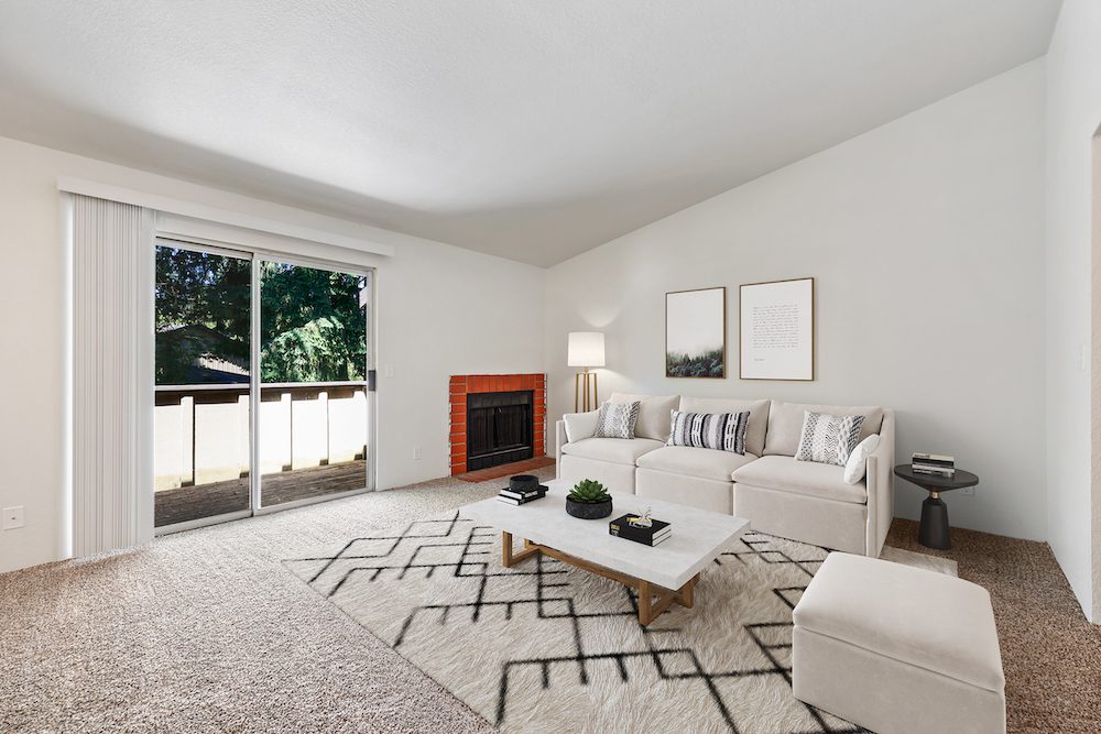 Living room with wood burning fireplace in a Sherwood Glen apartment home